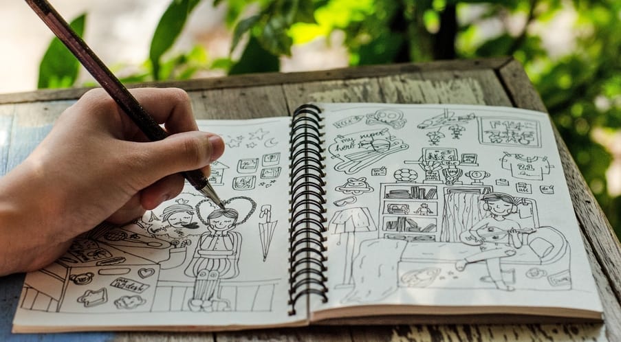 Teenage girl hand drawing cartoon and doodle for hobby